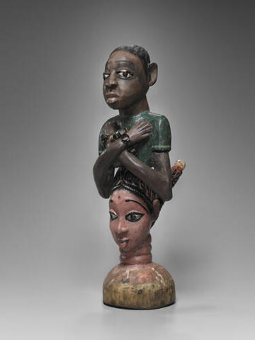 Headdress in the Shape of the Head of an Indian Woman Surmounted by a Male Figure with Shackles, Sierra Leone, mid-to late 20th century, 2006.51.567, Yale University Art Gallery.